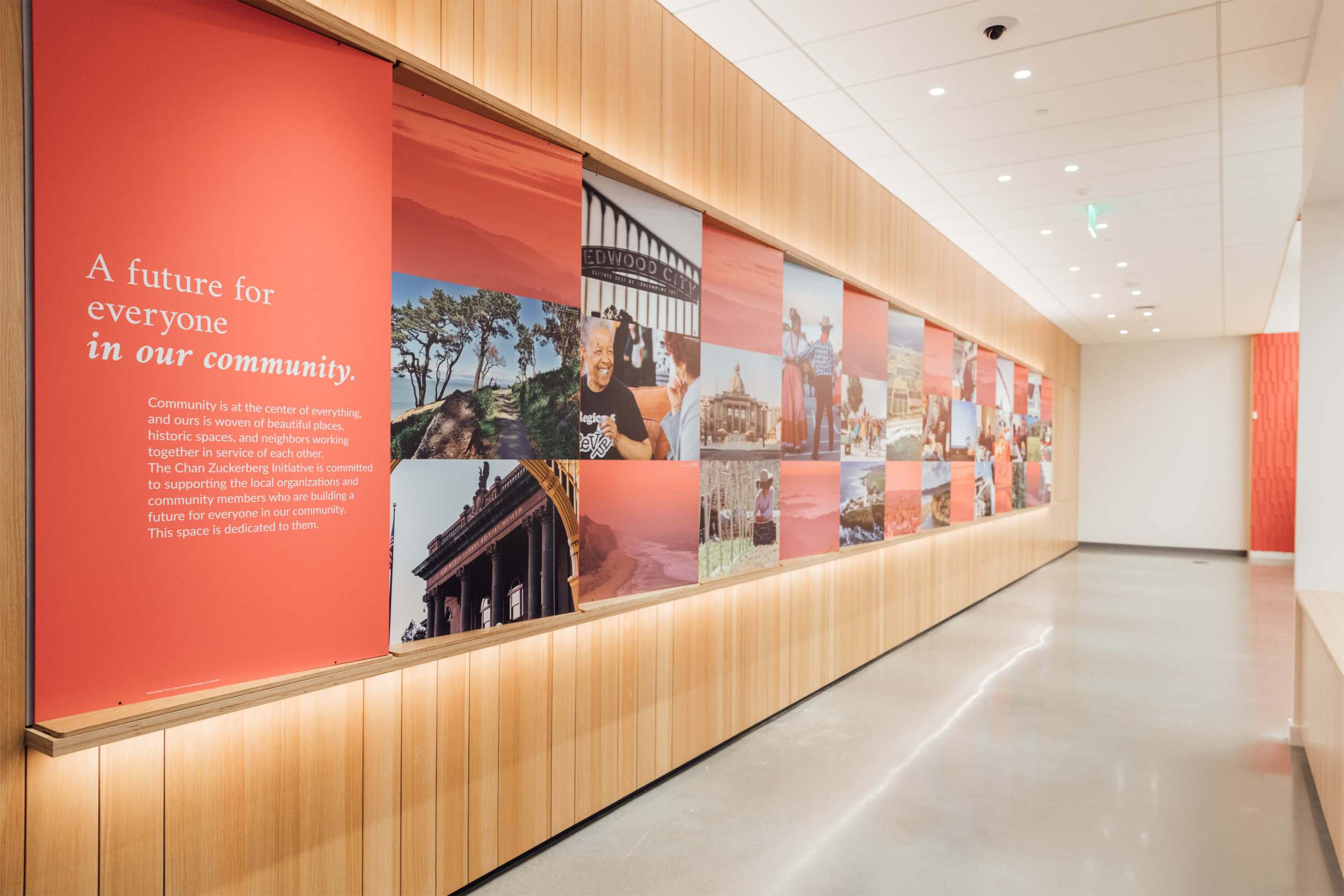 Empty room with large three-dimensional wall display of images and text.